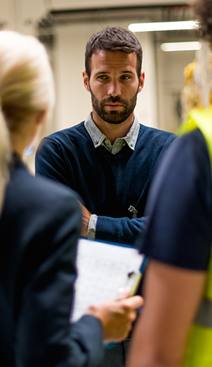 man in blue addressing coworkers